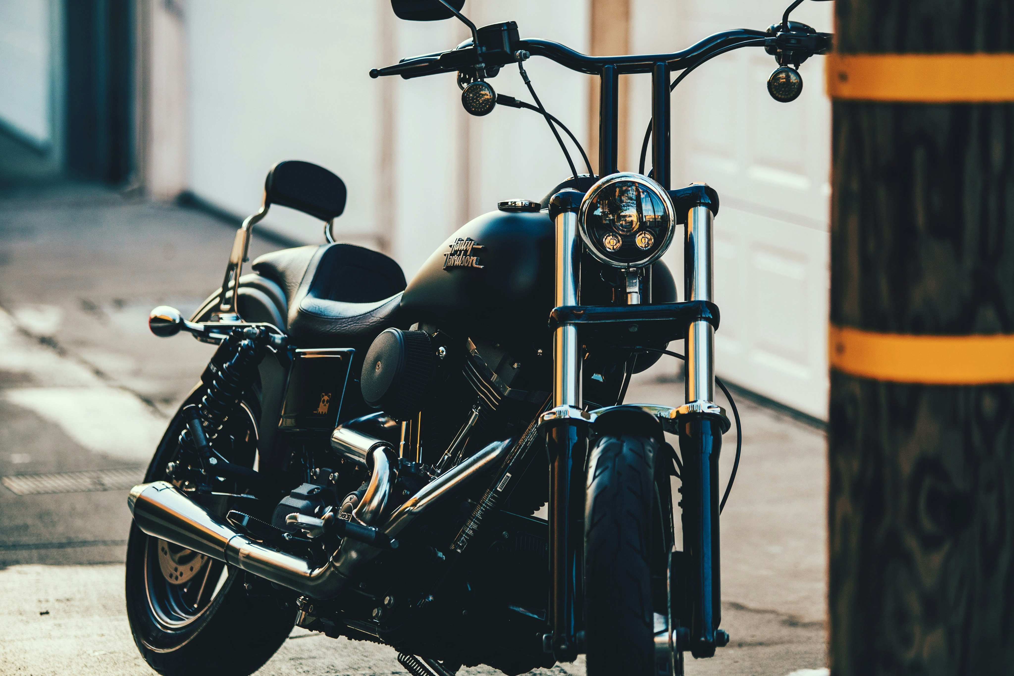 black cruiser motorcycle near black street post